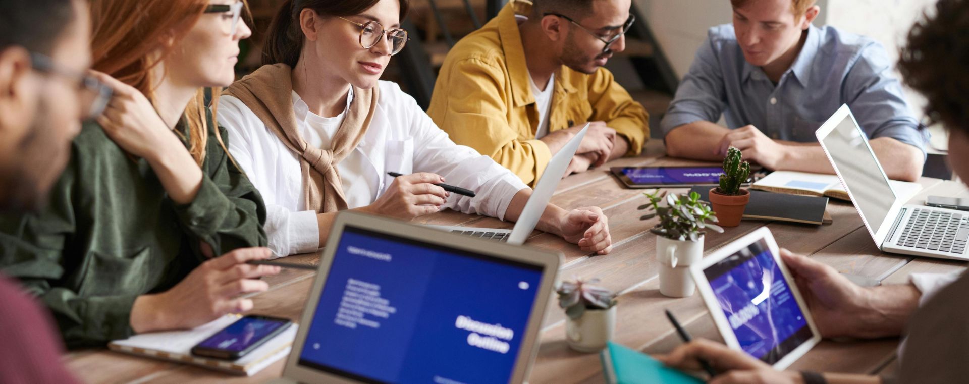 A diverse group of professionals having a collaborative meeting in a modern office setting.