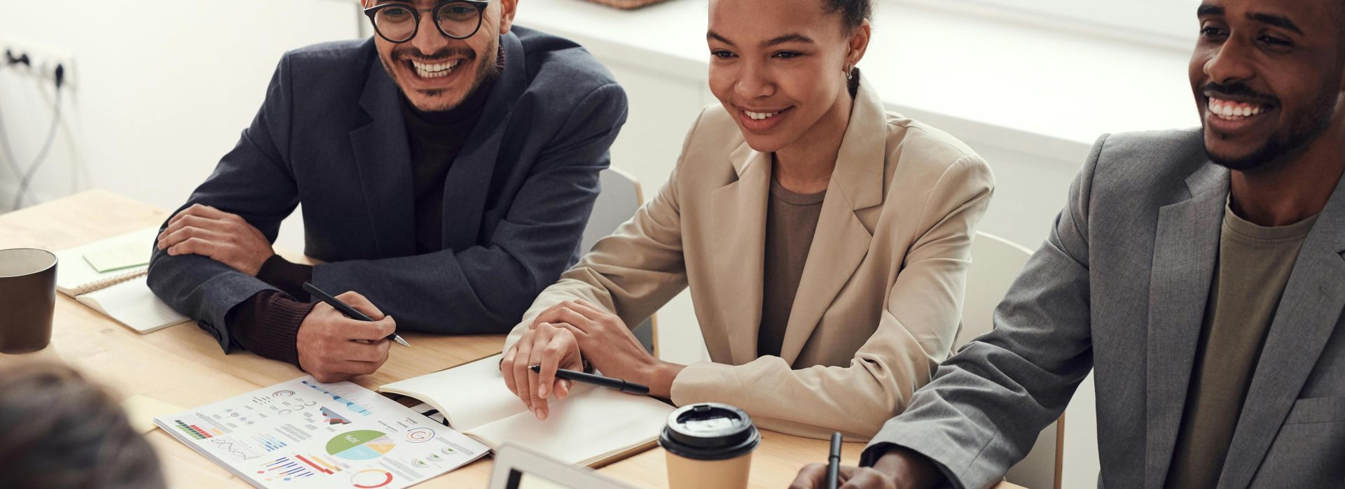 A diverse team of professionals having a meeting in a modern office setting, discussing business strategies.